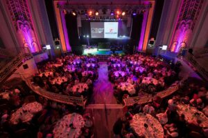 Birds eye view of round tables set up in Troxy's main auditorium.