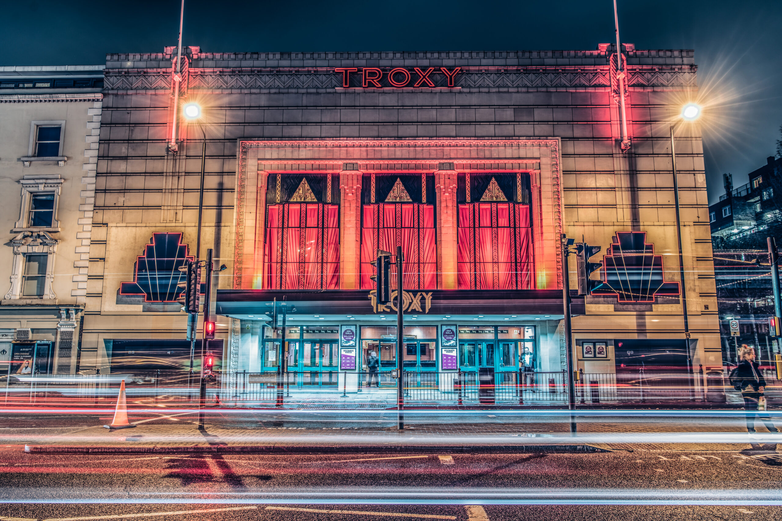 Troxy venue lit up at night, taken from the road with a slow exposure